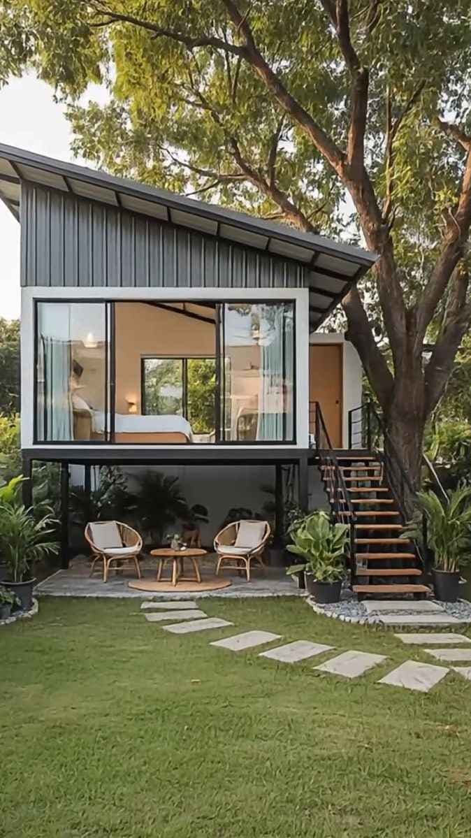 Two-level villa elevation with large glazing below mature trees